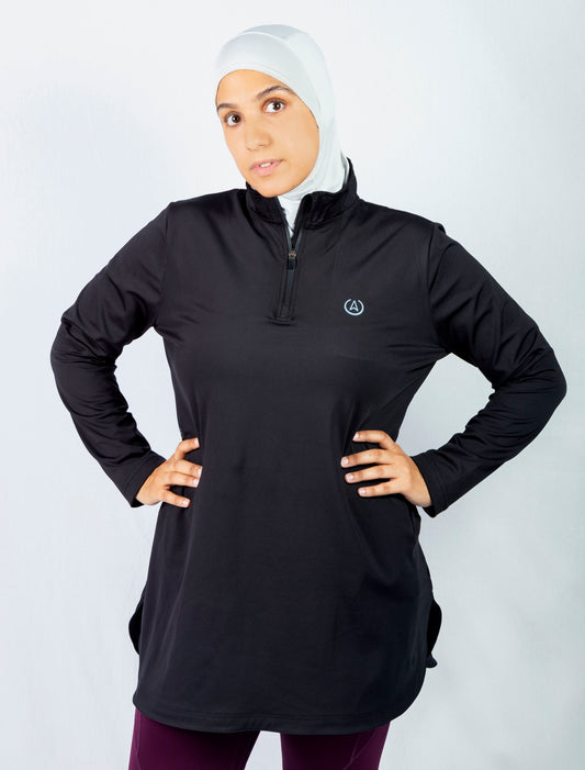 Long gym top. Modest athletic wear top in black. A mid thigh length with long sleeves and collar. Hijab friendly workout clothes.